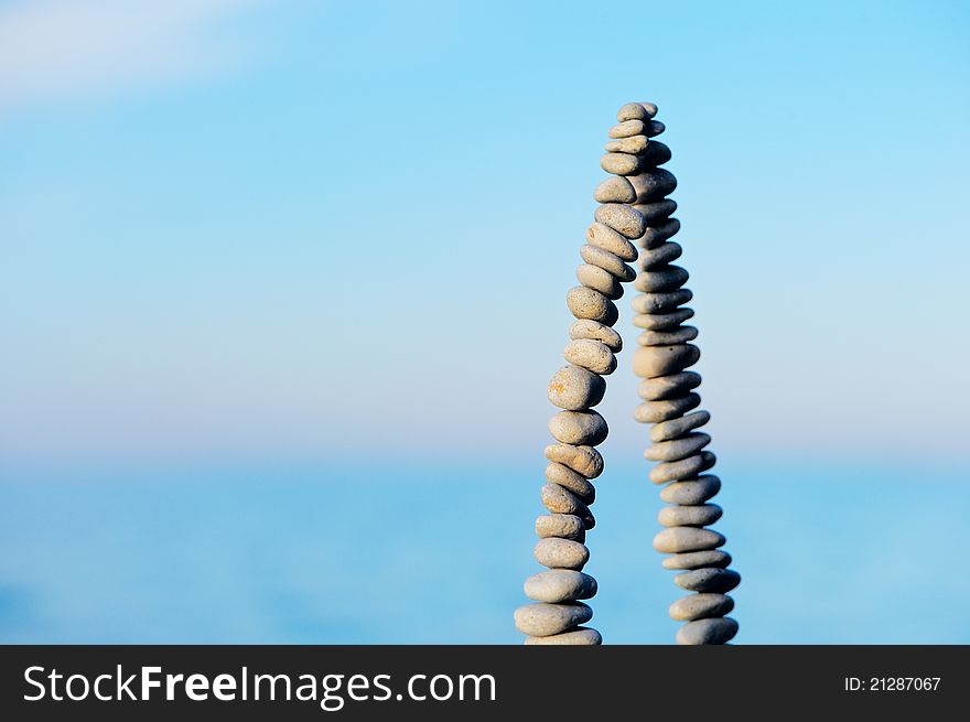 Pile of pebbles as pyramid against the background of sky. Pile of pebbles as pyramid against the background of sky