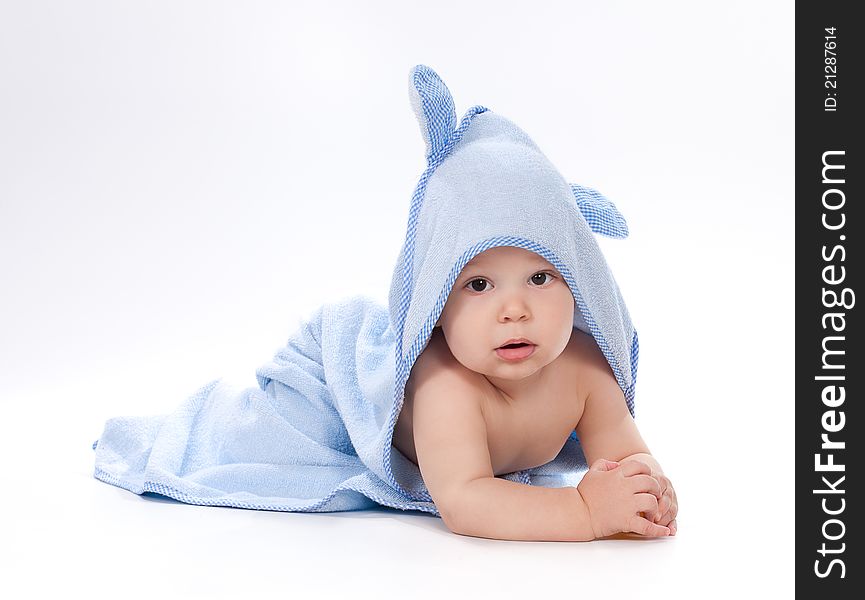 Baby under blue towel on white background