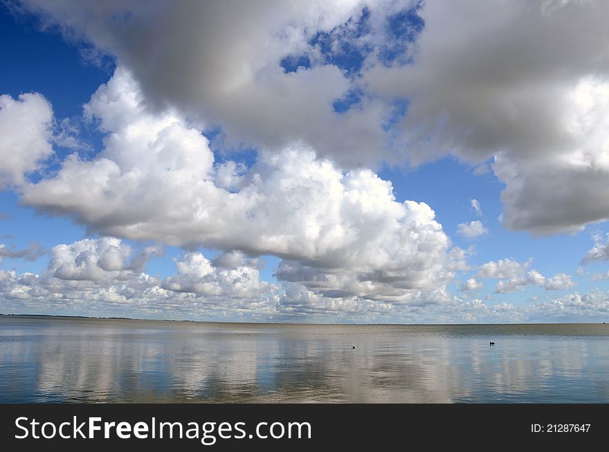 Summer end seascape with clouds reflections