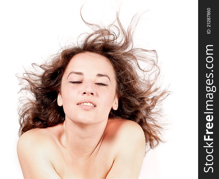 Beautiful woman with hair blown by wind on white background