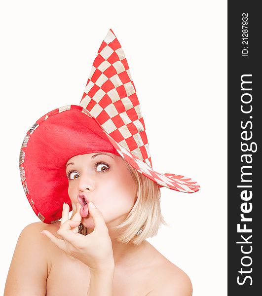 Woman in red hat making a funny face on white