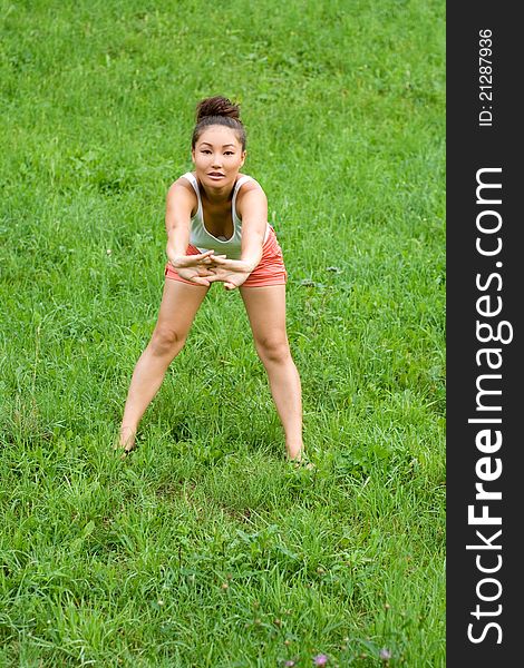 Girl doing exercises in park