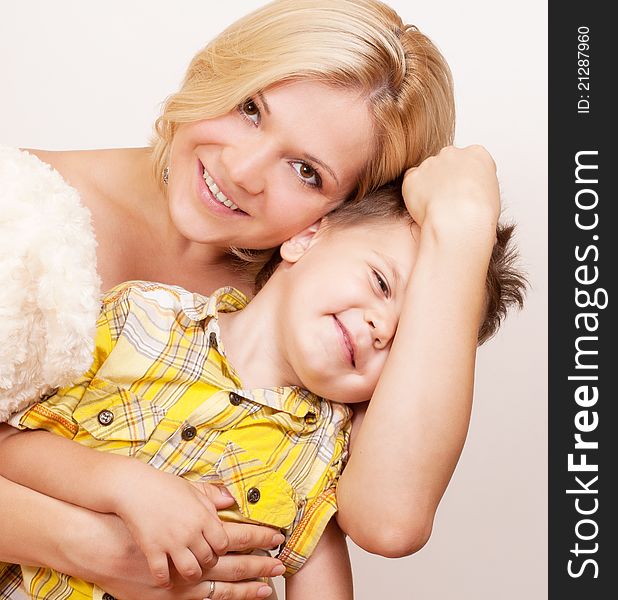 Happy mother with her child together on a white