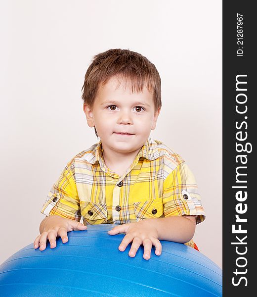 Boy with gymnastic ball on white background