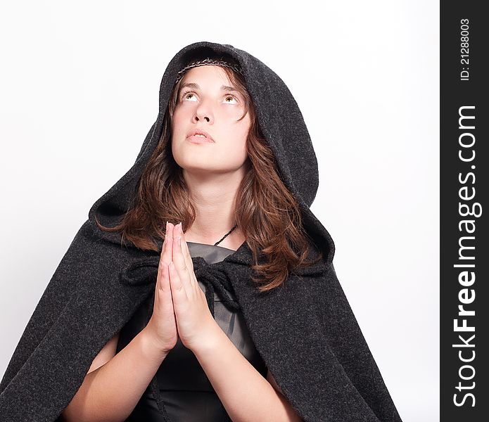 Praying woman in black hood on white background