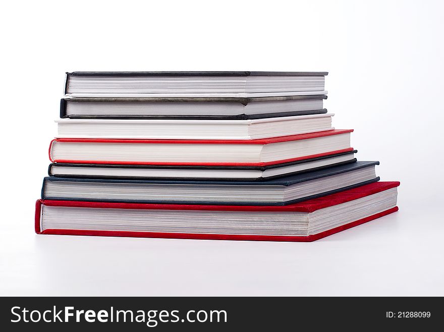 Stack of colorful books on white