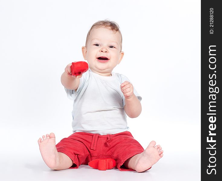 Baby playing with puzzle heart on white background