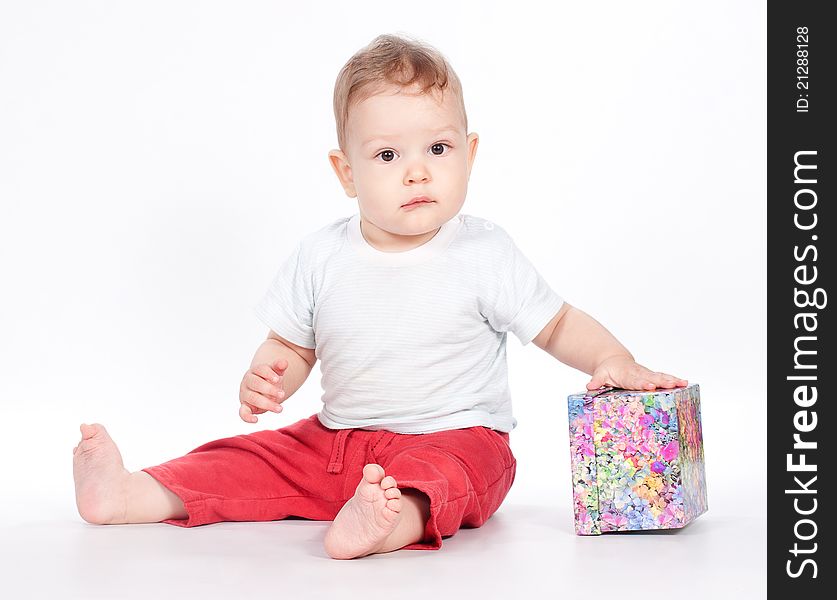 Baby boy opening gift box on white background