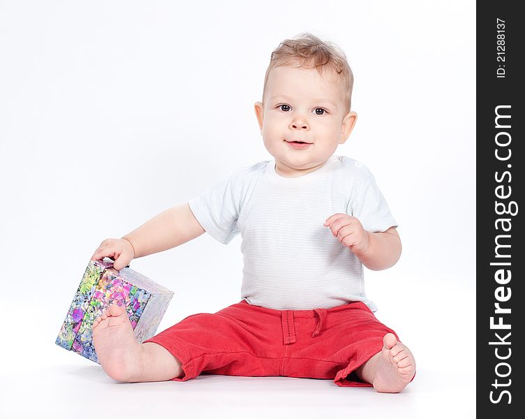 Baby boy opening gift box on white background