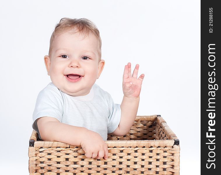 Baby boy in wicker basket on white background