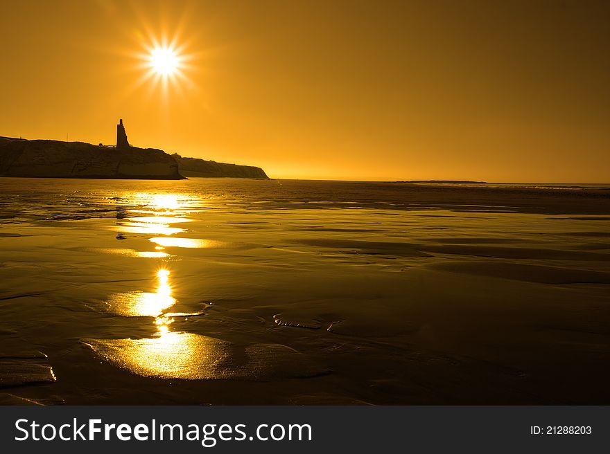 A scenic view of a castle on the irish coastline at ballybunion at sunset. A scenic view of a castle on the irish coastline at ballybunion at sunset