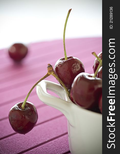 Macro image for Cherries on white plate and pink background. Macro image for Cherries on white plate and pink background