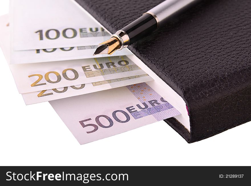 Monetary denominations in office notebook isolated on a white background