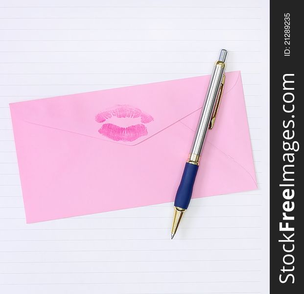 Pink envelope with a pen kiss print on it over the paper for writing