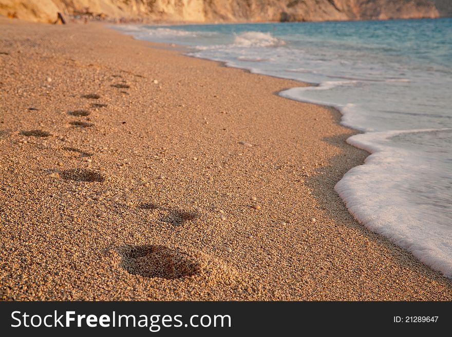 Barefoot steps on Egremni beach in Greece. Barefoot steps on Egremni beach in Greece