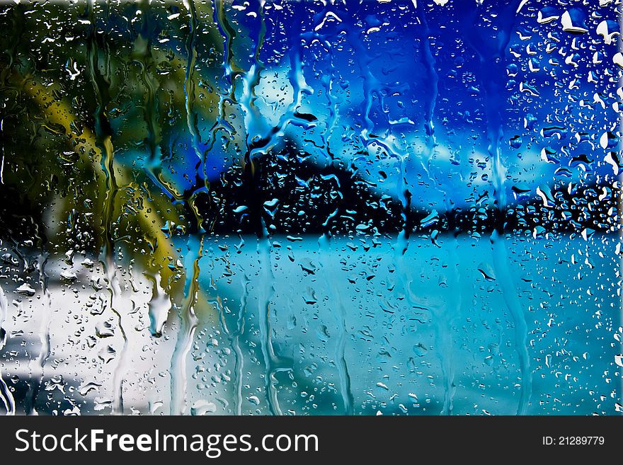 Background of sea and palm through wet window. Background of sea and palm through wet window