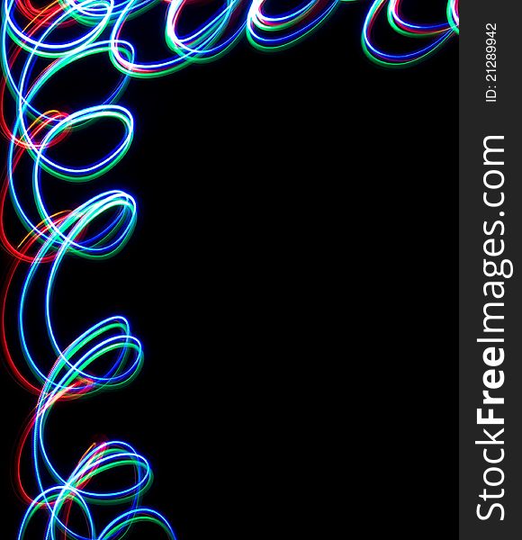 Frame of Chaotic colorful lights on black background