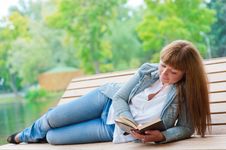 Young Woman Reading A Book Sitting On The Bench Royalty Free Stock Photography Young Woman Reading A Book Sitting On The Bench Royalty Free Stock Photography