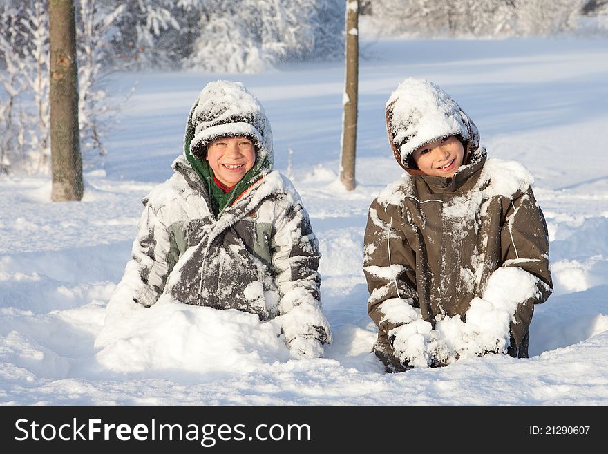 Two young boys playing in deep snow. Two young boys playing in deep snow