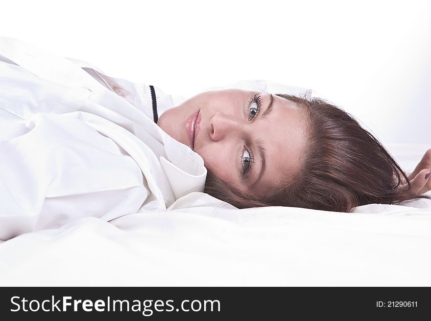 Beautiful girl lying on the snowy bed