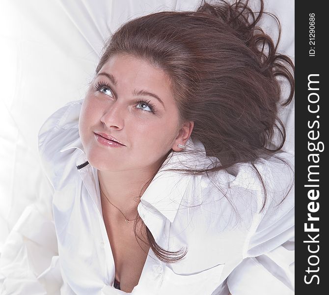 Beautiful girl lying on the snowy bed