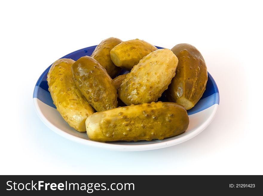 Cucumbers on a plate on a white background. Cucumbers on a plate on a white background