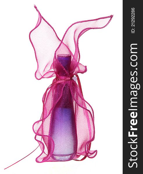 Perfume bottle in a gift sack isolated on a white background