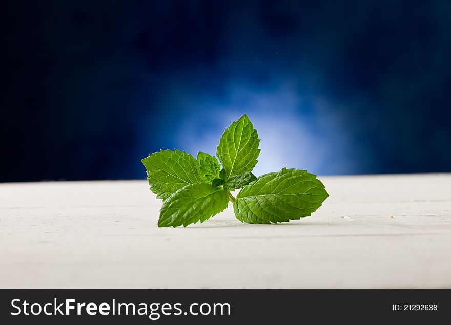 Mint Leaves On Wooden Table With Spot Light