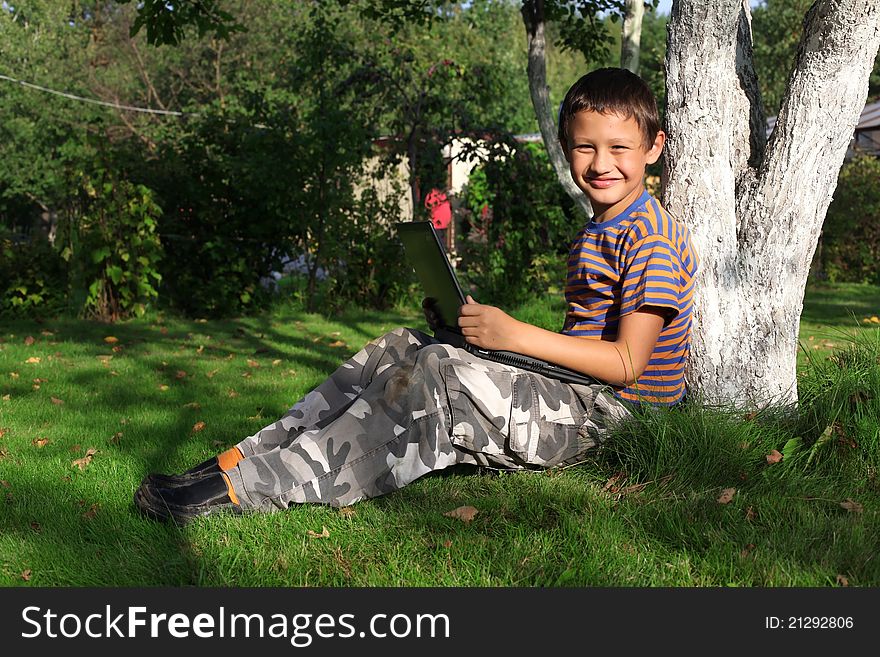 Boy On Laptop Outdoor