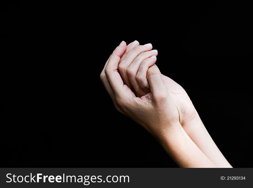 Woman hands isolated on black background.