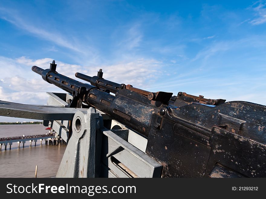 Old metal Machine gun on battleship point into sky