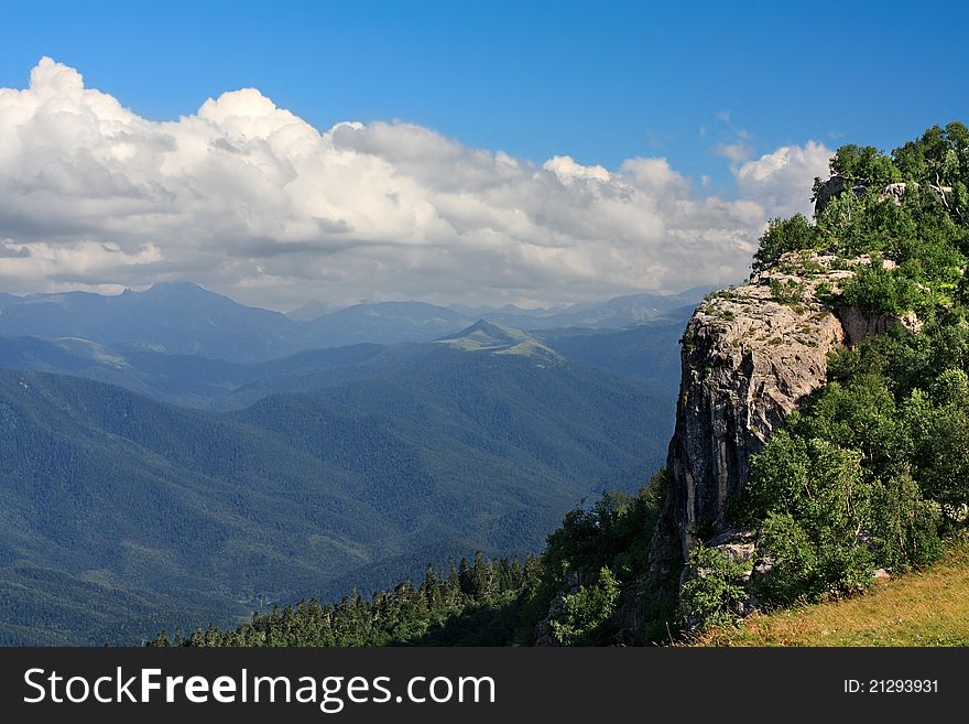 Steep rock on the background of mountain ranges. Steep rock on the background of mountain ranges.