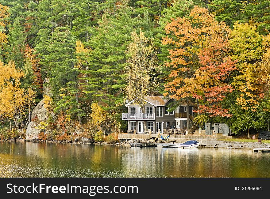 Autumn scene of a cottage on the lake. Autumn scene of a cottage on the lake.