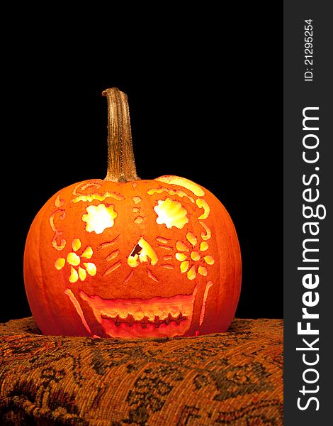 Happy Jack O' Lantern with intricate pattern carved out. Happy Jack O' Lantern with intricate pattern carved out.