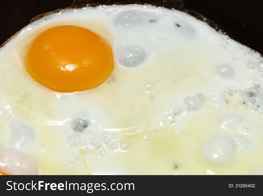 Pan full of scramble eggs in a frying pan
