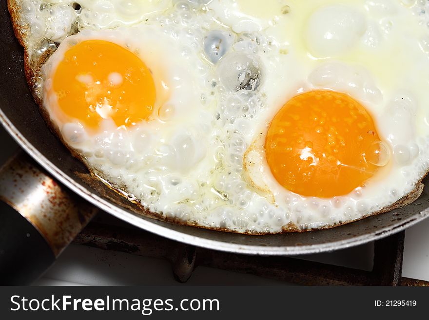 Pan full of scramble eggs in a frying pan