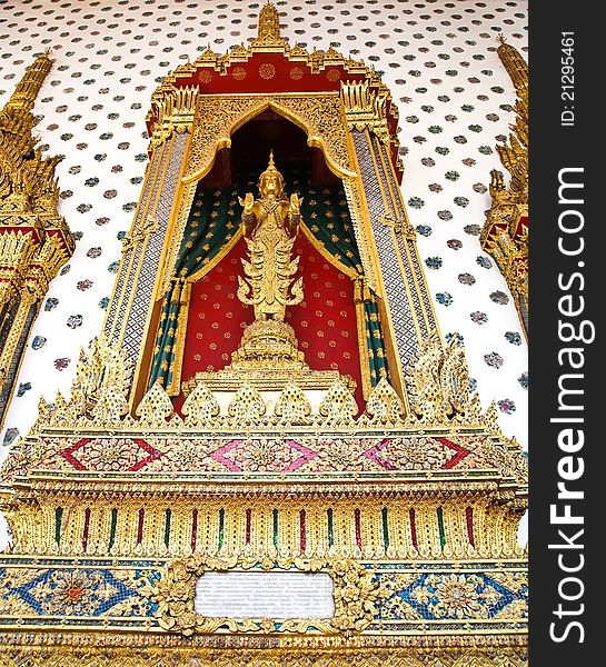 Thai style god (Deva) Golden Statue at the Wat Arun (Temple of the Dawn) is a Buddhist temple (wat) in the Bangkok Yai district of Bangkok, Thailand with blue sky and River background .