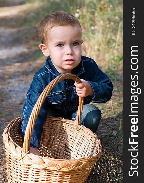 Cute boy with basket in a forest. Cute boy with basket in a forest