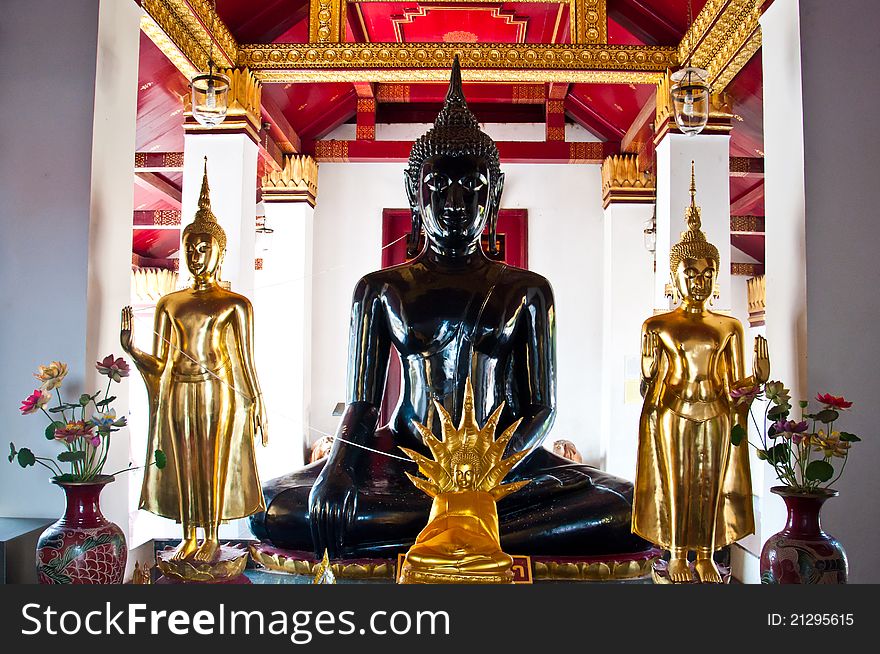 Black buddha image and three gold buddha image. Black buddha image and three gold buddha image