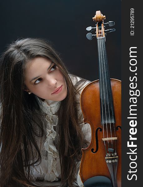 Pretty girl with violin isolated on black