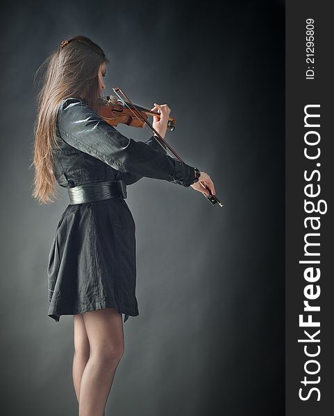 Pretty girl with violin isolated on black. Pretty girl with violin isolated on black