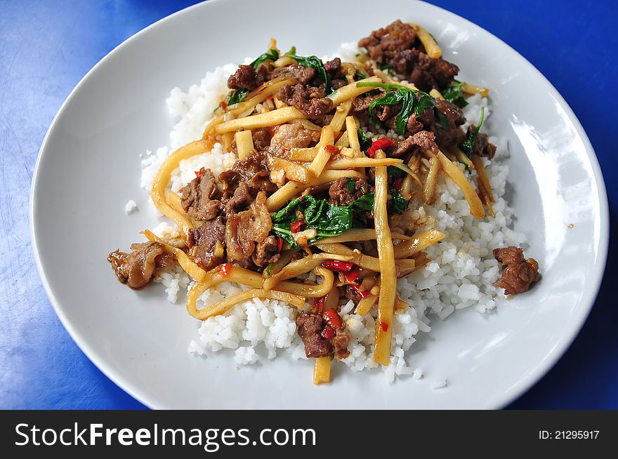 Rice topped with stir fried hot and spicy pork with basil and asparagus, Thailand