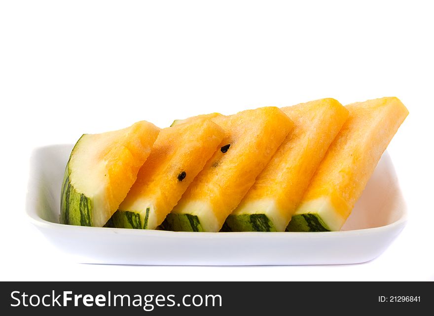 Slice yellow watermelon in a package on white background