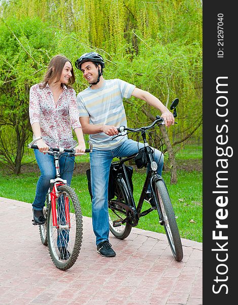 Happy Young Couple Riding Bicycles