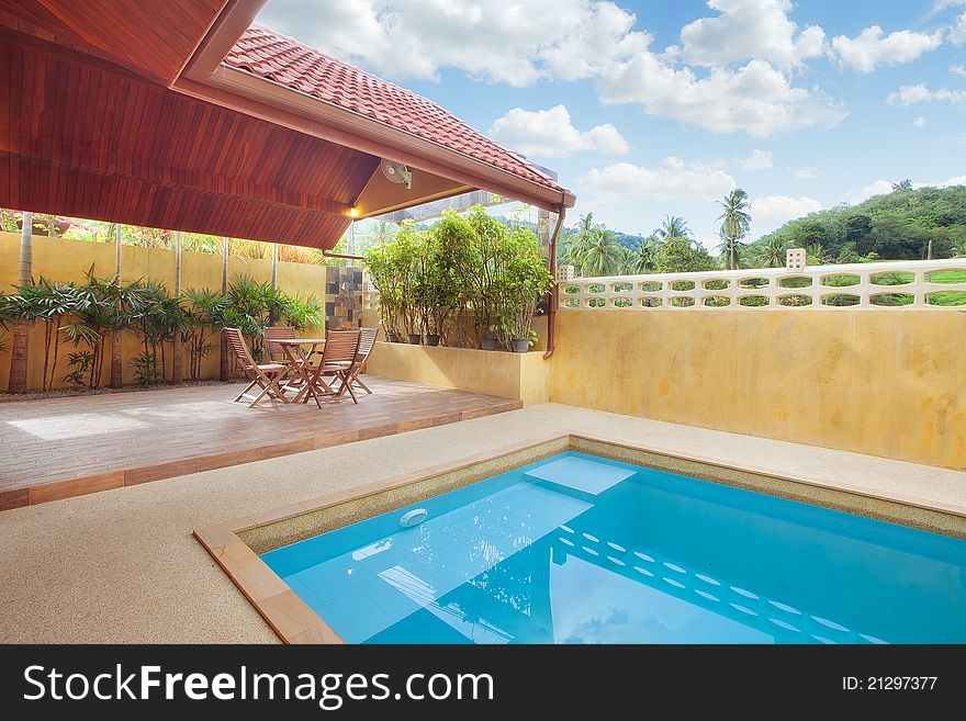 Panoramic view of nice summer house patio with swimming pool