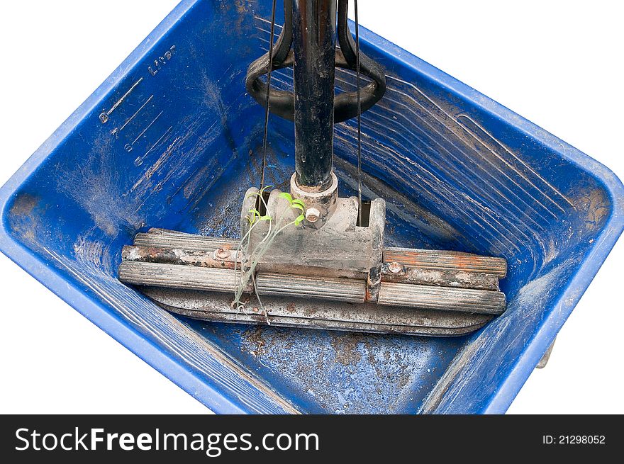 Old mop with green sprouts in a dirty bucket isolated on white background