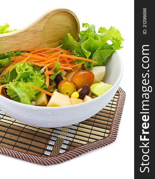 Bowl of salad with wooden spoon
