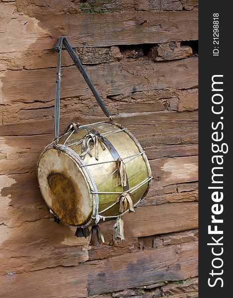 Vintage drum ritual, against a wooden wall