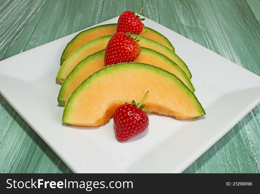 Melon Slices on White Plate. Melon Slices on White Plate