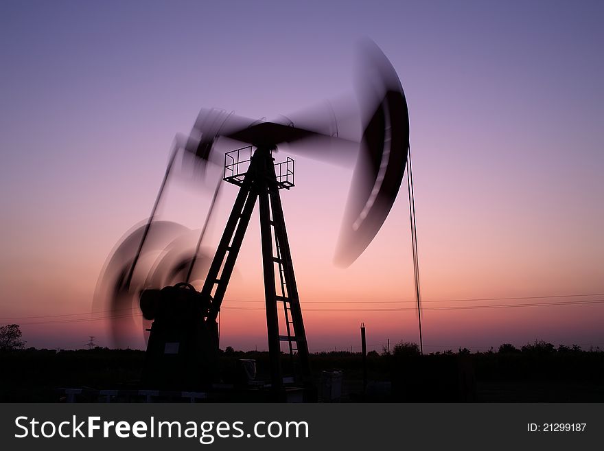 Pump jack silhouette at sunset